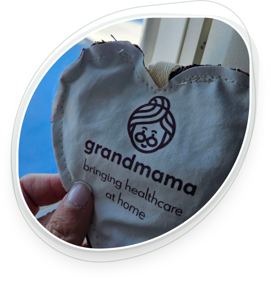 Cropped photograph of heart-shaped knit with text "grandmama", transparent